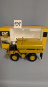 A NORSCOT 1:50 CAT 777D Off Highway Truck with Klein Water Tank. Collectible Die-Cast Scale Model
