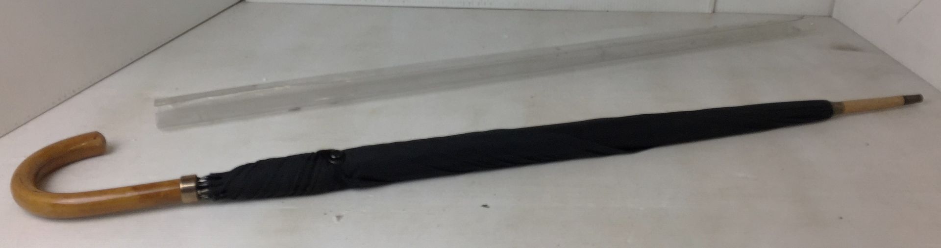 A wooden handled black gents umbrella used and in original plastic cover (CWH Ref: N06)