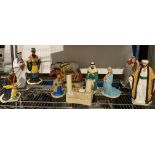 A nativity scene featuring plaster figures, animals and crib with baby Jesus,
