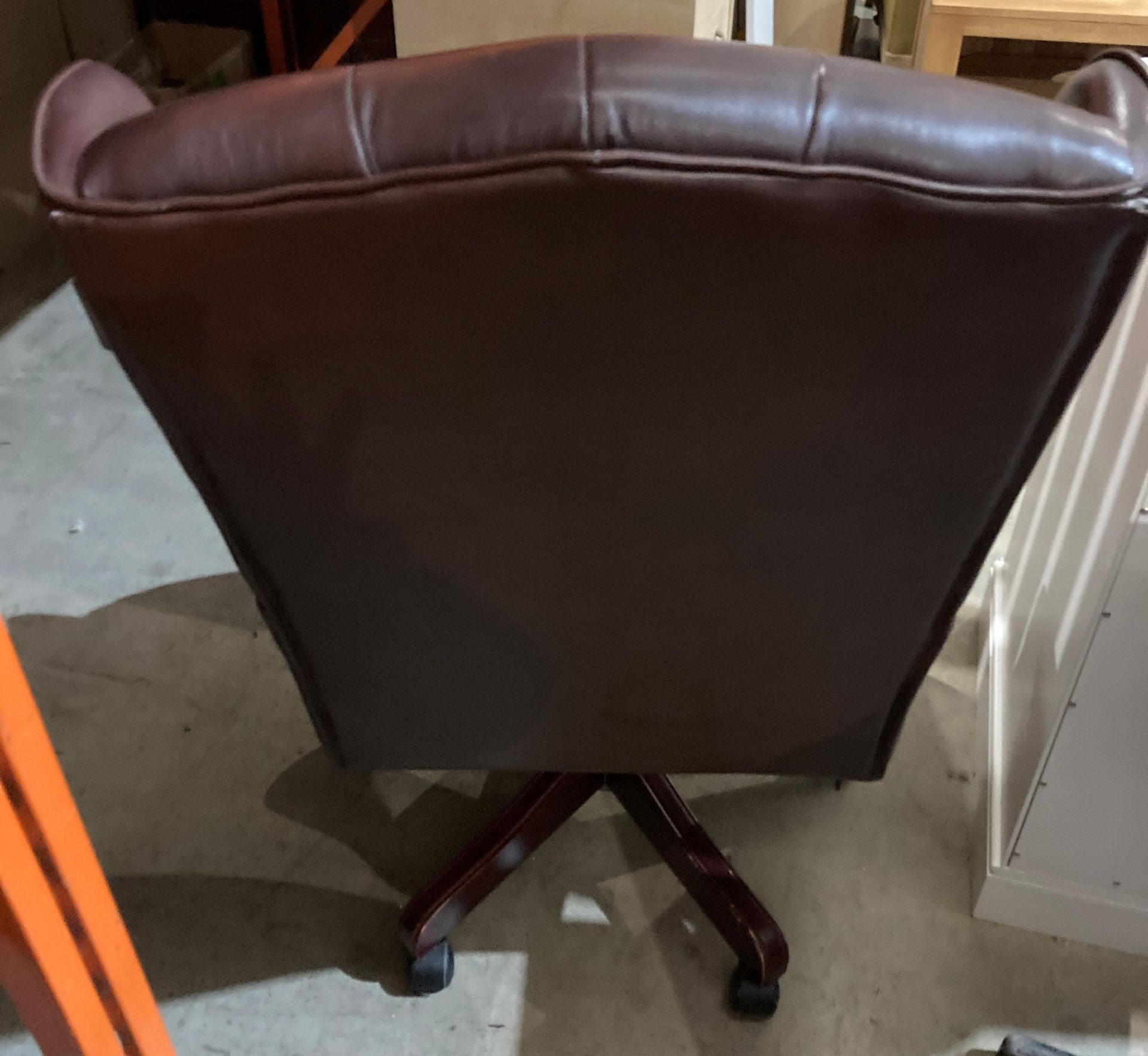 A brown leather high deep buttoned back and seat swivel armchair - please note: slight tear to arms, - Image 4 of 5