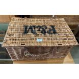 A wicker picnic basket labelled F&M,
