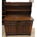 An Ercol-style Welsh dresser with plate rack and two-drawer two-door base with carved drawer fronts,