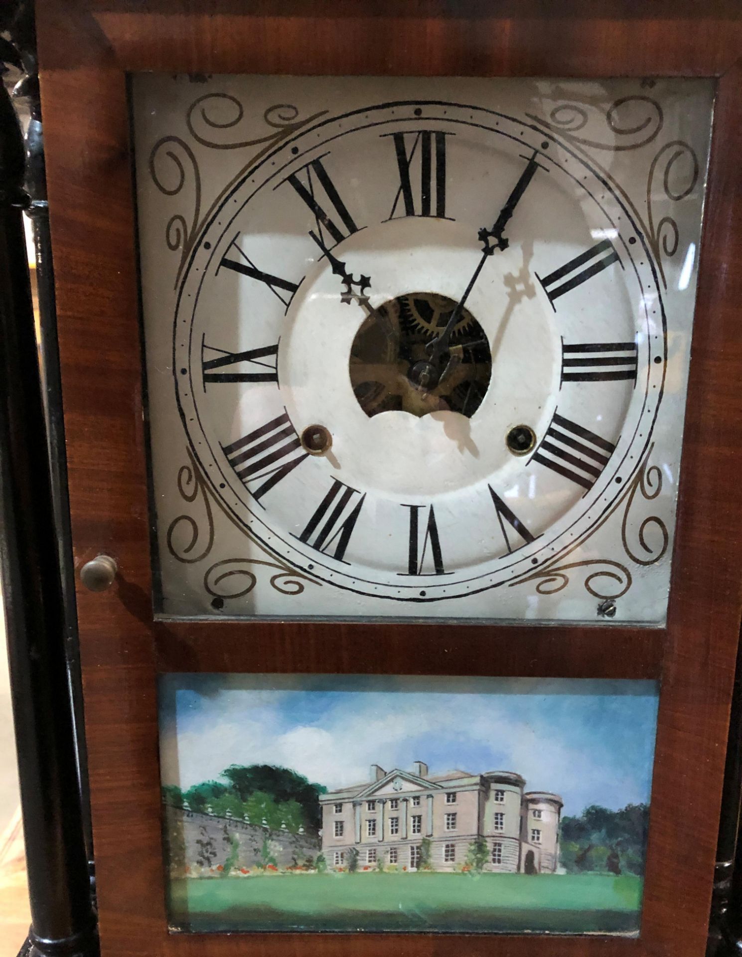 A mahogany framed American wall clock with hand-painted glass panel ...