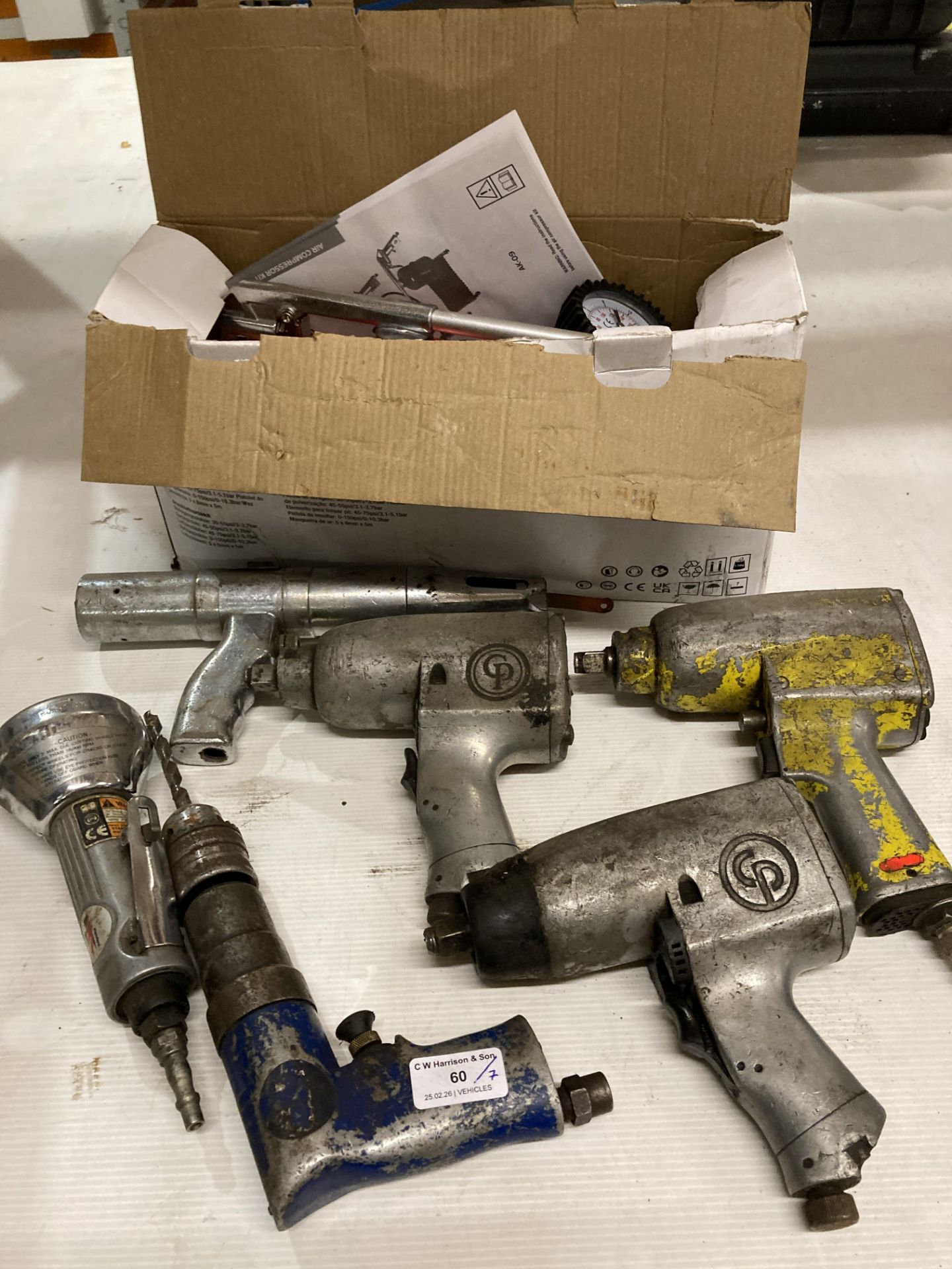 Seven assorted pneumatic tools including air compressor kit, three wrenches,