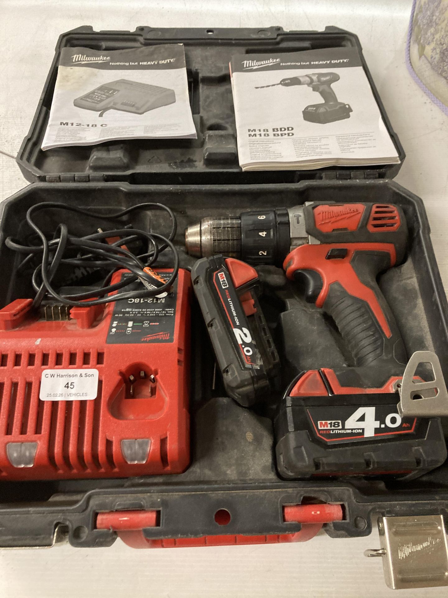 A Milwaukee M18 18v cordless drill complete with two batteries,