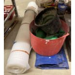 A large blue tarpaulin, together with building buckets,