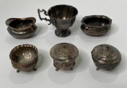 Three silver hallmark items; two assorted condiment dishes, a tea cup,