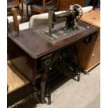 A vintage 'Jones' Medium CS 43805 manual foot-operated sewing machine on a cast metal and mahogany