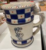 A Crown Ducal George VI 1937 mug in white, blue, and red dotted pattern by Charlotte Rhead,