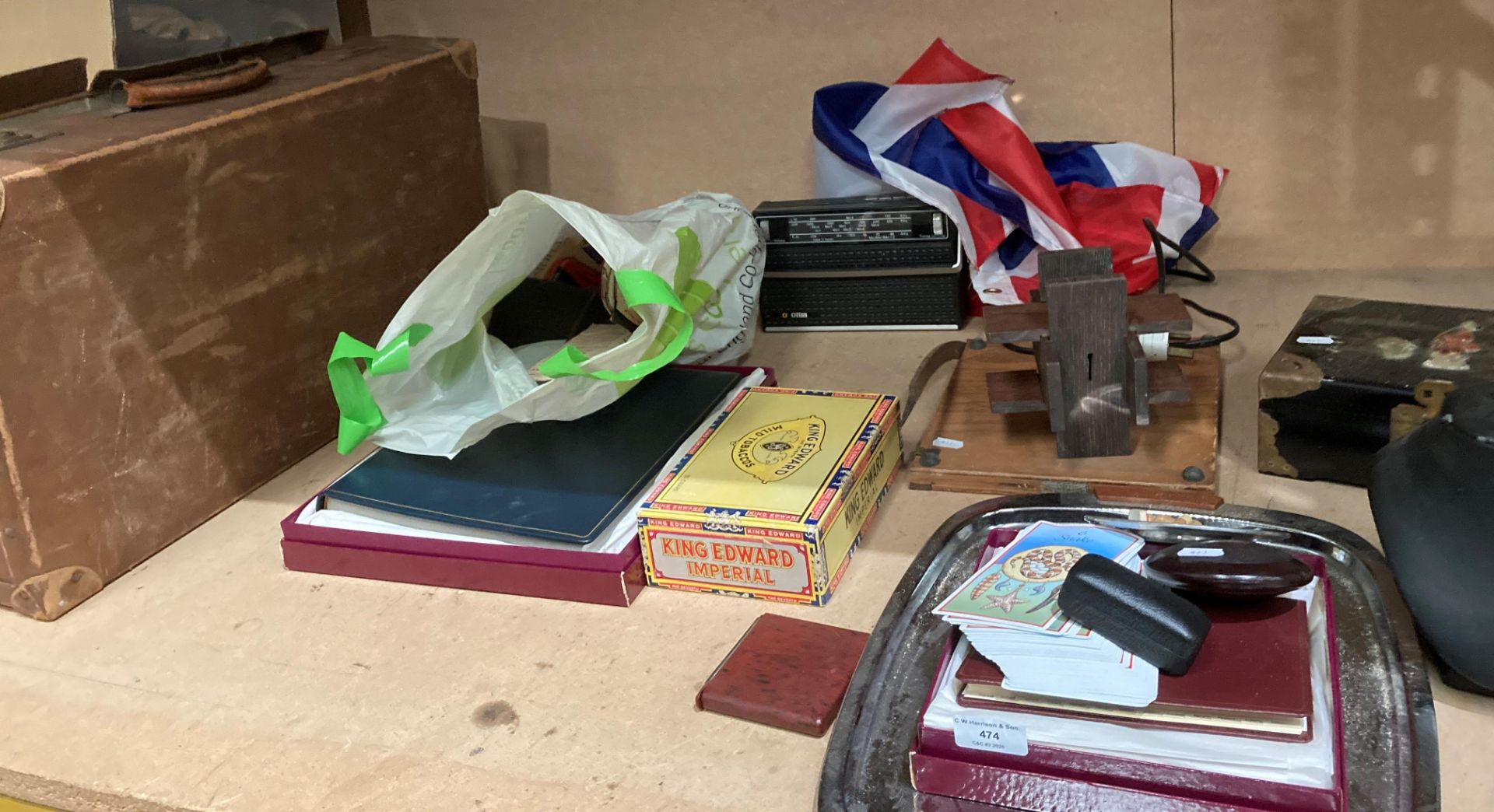 Contents to part shelf; brown fibre suitcase, portable radio, small guillotine,