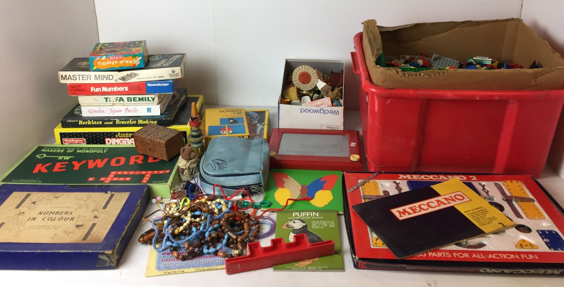 Thirty plus items mainly toys including red plastic box full of Lego,