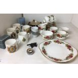 Twenty pieces of rose-decorated tea service, silver serviette ring, miniature metal canon,