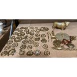 A brass well and a quantity of individual horse brasses, etc.