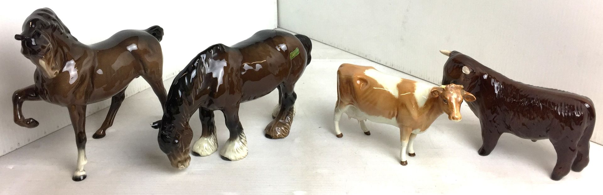 Four items including three Beswick animals including bay prancing stallion19cm high (repair to