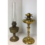 Two brass oil lamps including one with glass chimney 60cm high,