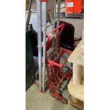 A red metal framed folding sack cart,