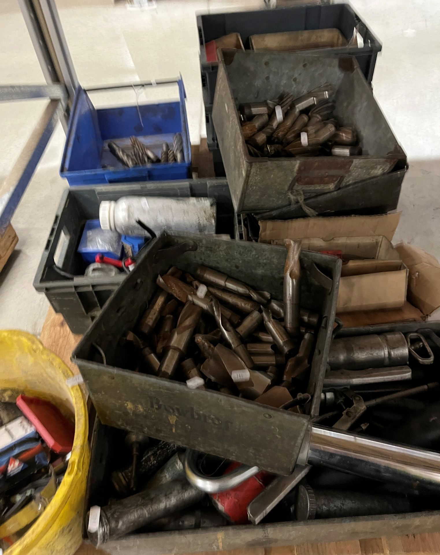 Contents to pallet - a quantity of HSS drill bits, grease guns, steel pipe clamps,