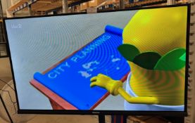 Hisense32" Smart TV model 32A4NTUK on an adjustable black metal stand,
