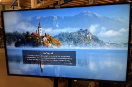 LG 49" Smart TV model 49UM7400PLB on black metal mobile stand complete with power lead and remote
