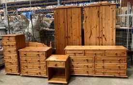 Seven pieces of pine bedroom furniture comprising two x two door wardrobes,