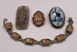 A silver hallmark 800 hand-carved cameo panelled bracelet,