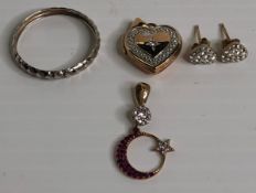 Four 9ct gold items including a gold (375) ring, moon and star pendant, love heart locket,