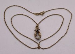 A 9ct gold 375 pearl and sapphire loop pendant with a 9ct gold 18" chain, approximate weight: 2.
