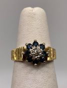 A 18ct gold diamond and sapphire ring with bark finish, size K, approximate weight: 3.