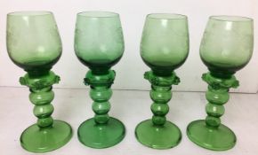 Four green Bohemian wine glasses etched with a vine pattern (two chips to base of one) (CWH Ref:
