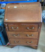 A mahogany with line inlay bureau with fall flap over three drawers,