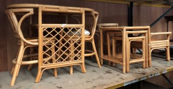 A cane glass top table with two matching chairs,