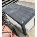 A dark and light grey plastic garden storage box,