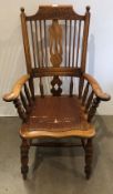 An early 20th century elm grandfather chair with turned leg supports and spindles (CWH Ref: MA5)