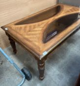 A medium oak finish coffee table with two glass inserts 130cm x 75cm.