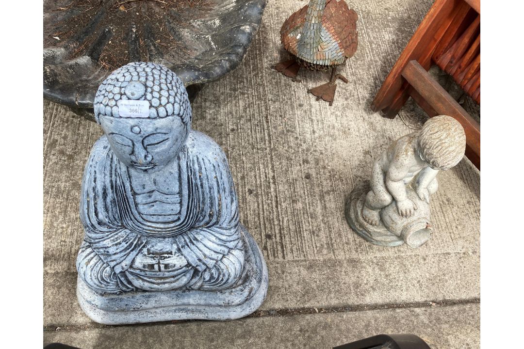A grey painted concrete garden Buddha,