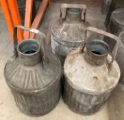 Three vintage ribbed galvanised motor oil cans with handles but no caps,