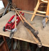 A red metal trolley jack and two pairs of vintage cane ski poles (CWH Ref: MA7)