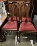 A set of four pierced vase splat-back dining chairs with red fabric.