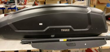 A Thule top box (locked,