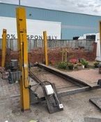A yellow metal four-post ramp,