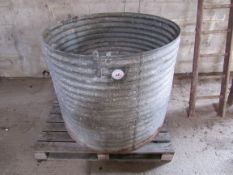 Circular galvanised bin with scrap metal inside
