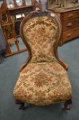 Victorian Mahogany Nursing Chair with Carved Detail and Floral Tapestry Upholstery