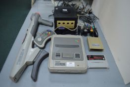 Super Nintendo, Game Cube, Super NES Scope Gun, and Controllers, etc.
