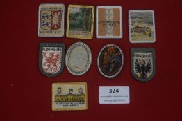 A mixed group of German WHW and civic woven badges, including examples marked Aschberg Heimatfest,