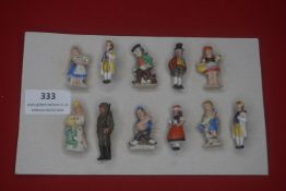 A group of German ceramic WHW-style miniature figures, depicting men, women and children in