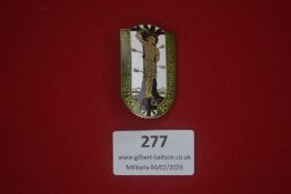 German patriotic enamel badge depicting a standing haloed figure, likely St Sebastian, against a