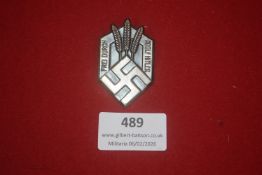 German Third Reich enamelled tinnie, shield-shaped, bearing the legend “Frei durch Arbeit” and “