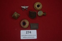 Group of assorted military and uniform insignia, including cap badges, buttons and collar devices,