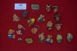 A mixed group of German WHW ceramic badges and miniatures, including character heads, symbolic