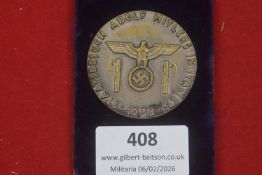 A Third Reich medallion inscribed “Staatsbesuch Adolf Hitlers in Italien 1938”, featuring an eagle